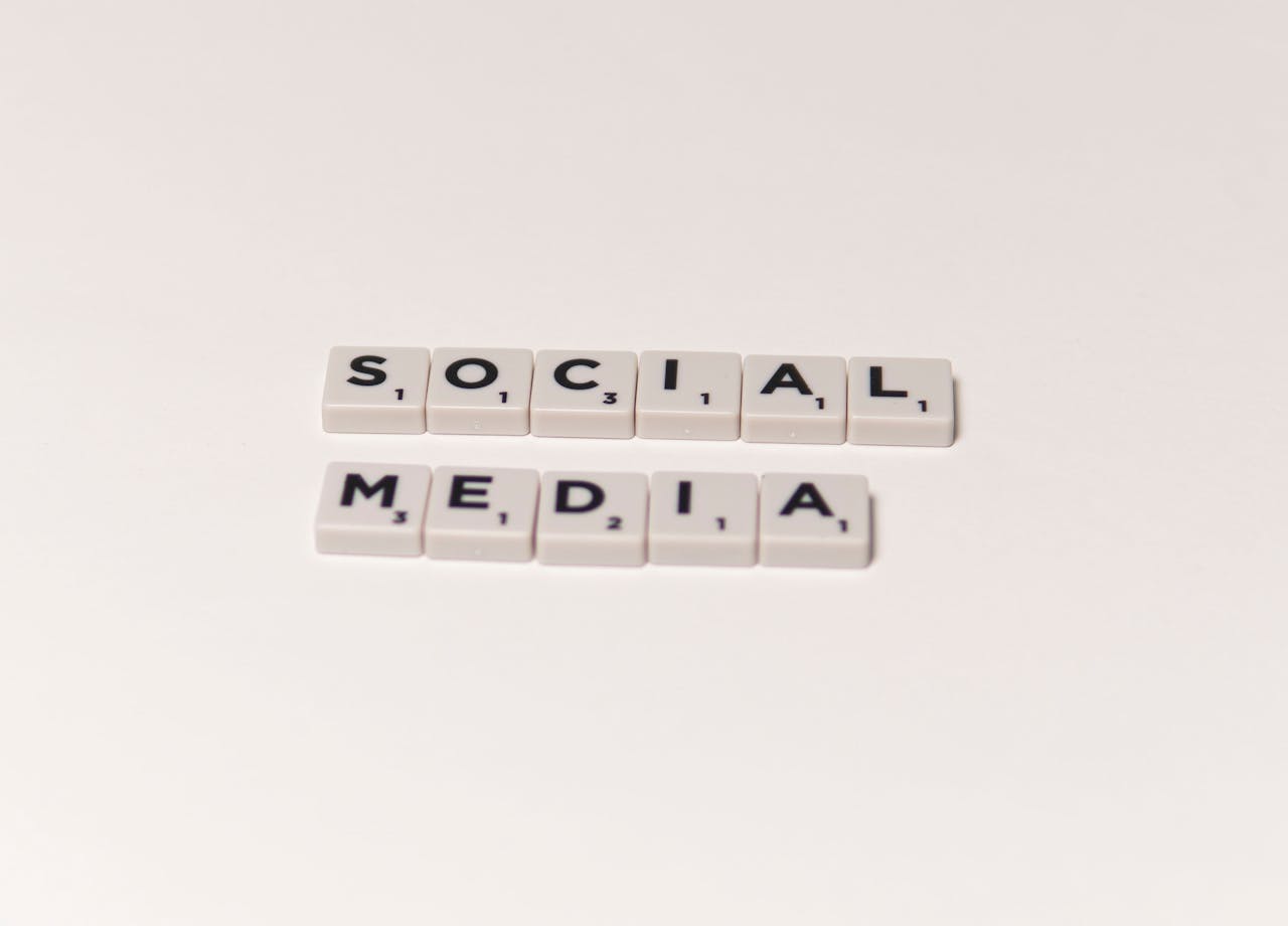home-hero-bg Scrabble tiles spelling social media on a white background, representing digital communication concepts.